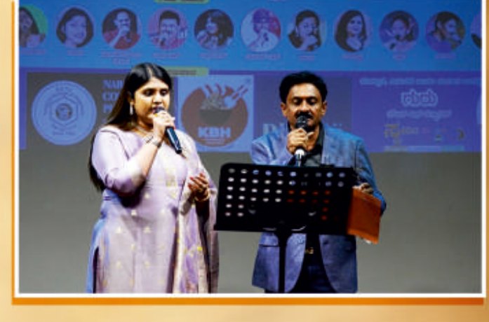 Dr. Pavithra singing on stage with a fellow artist