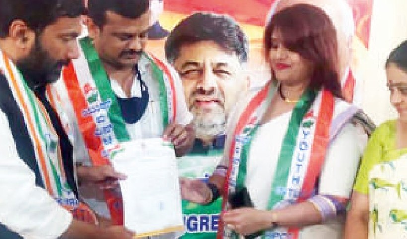 Dr. Pavithra receiving a Congress party appointment letter